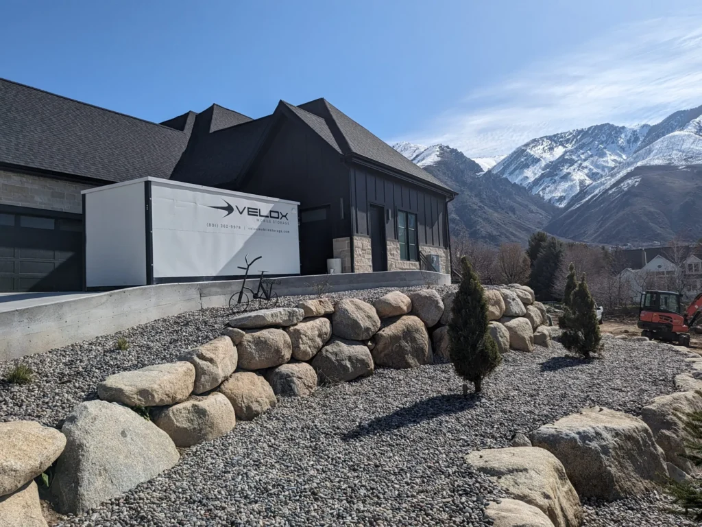 A Velox Mobile Storage container delivered to a Utah home with the Wasatch mountains behind it