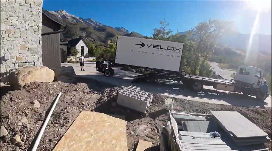 Velox portable storage unit being delivered to home construction site