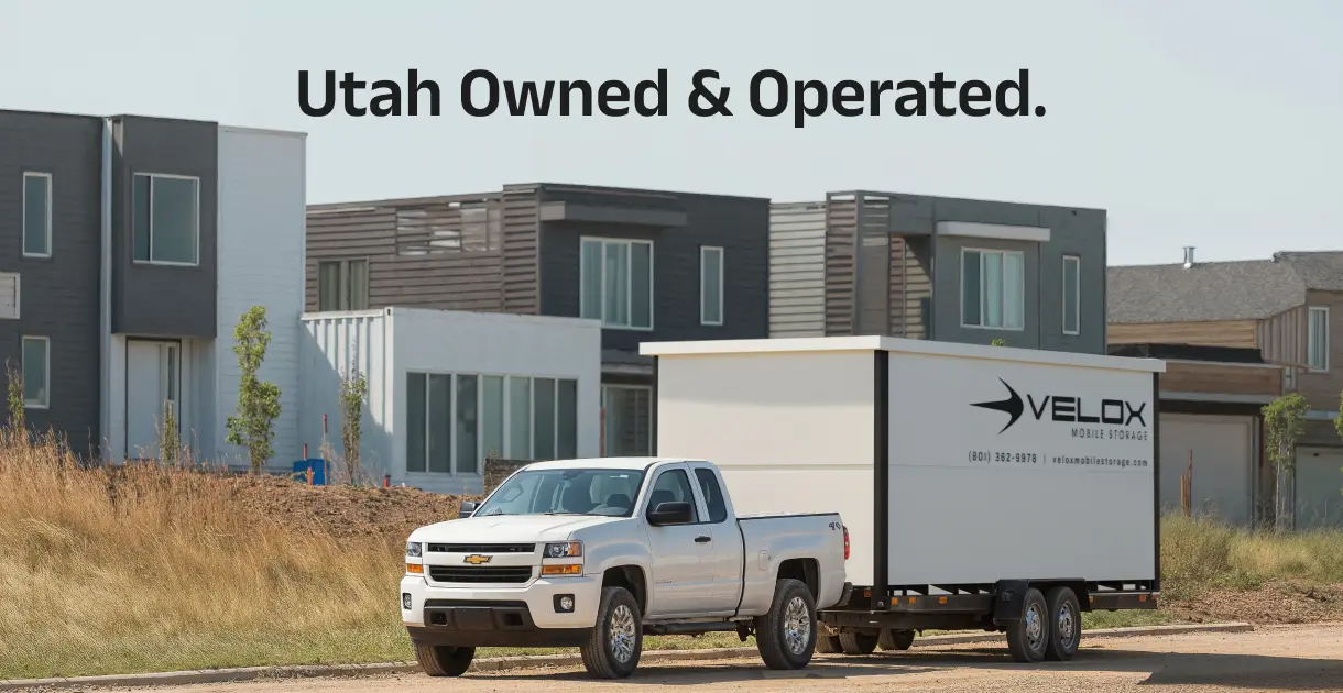 A Velox mobile storage container on a Utah residential driveway with the Wasatch Mountains in the background, comparing local moving services to PODS.