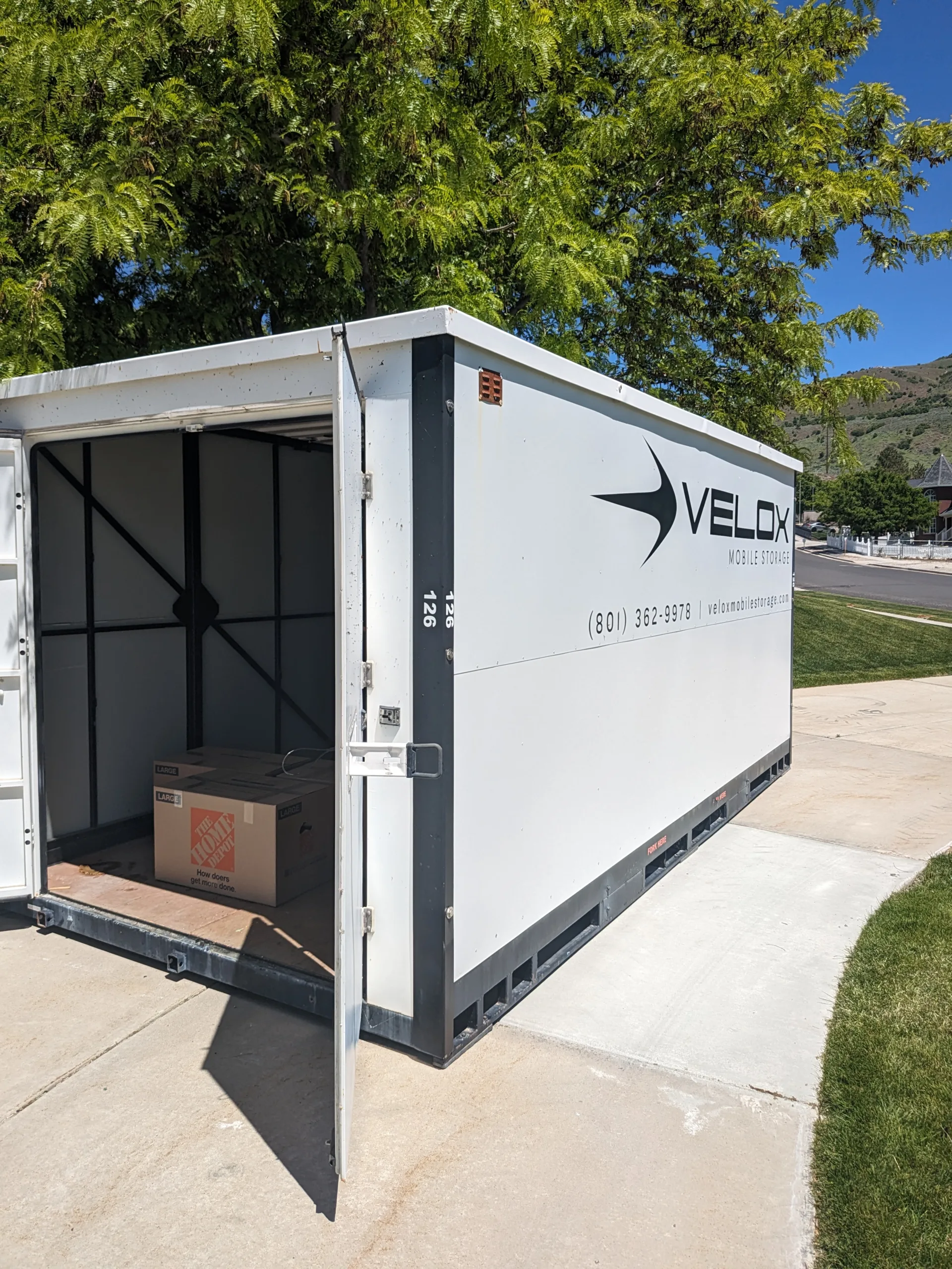 An empty Velox container with its door open, ready to be loaded