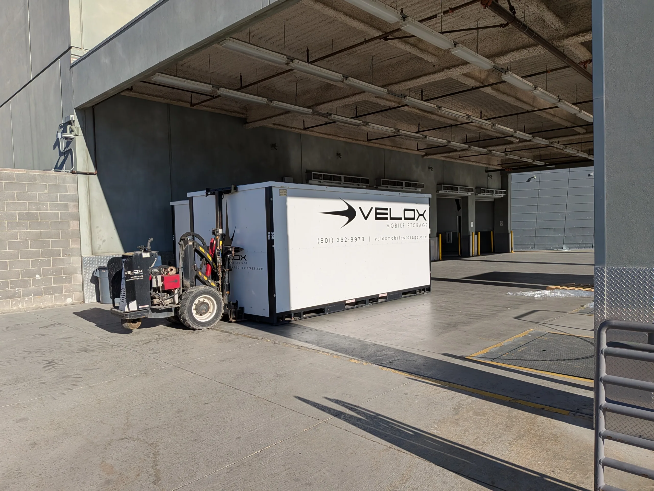 A Velox Mobile Storage container at a covered loading area