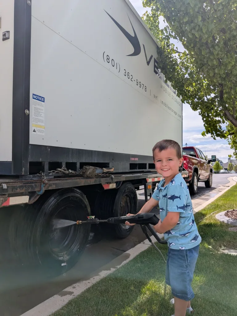 A Velox Mobile Storage container on the delivery trailer in a Spanish Fork neighborhood