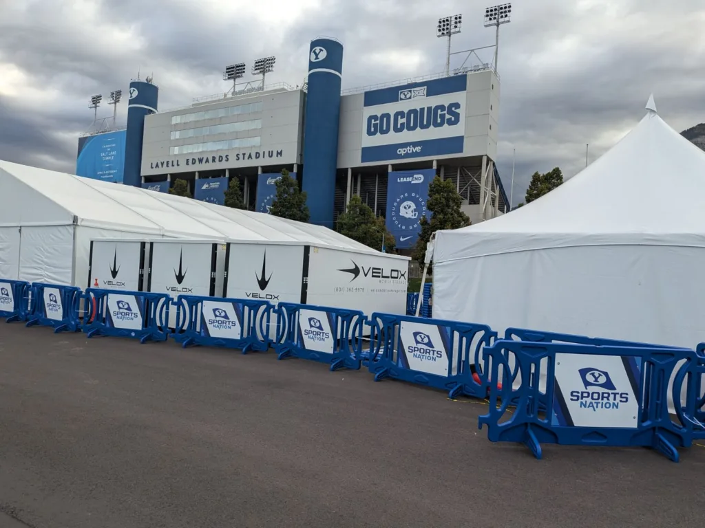 Velox Mobile Storage containers lined up between event tents outside LaVell Edwards Stadium on a BYU game day