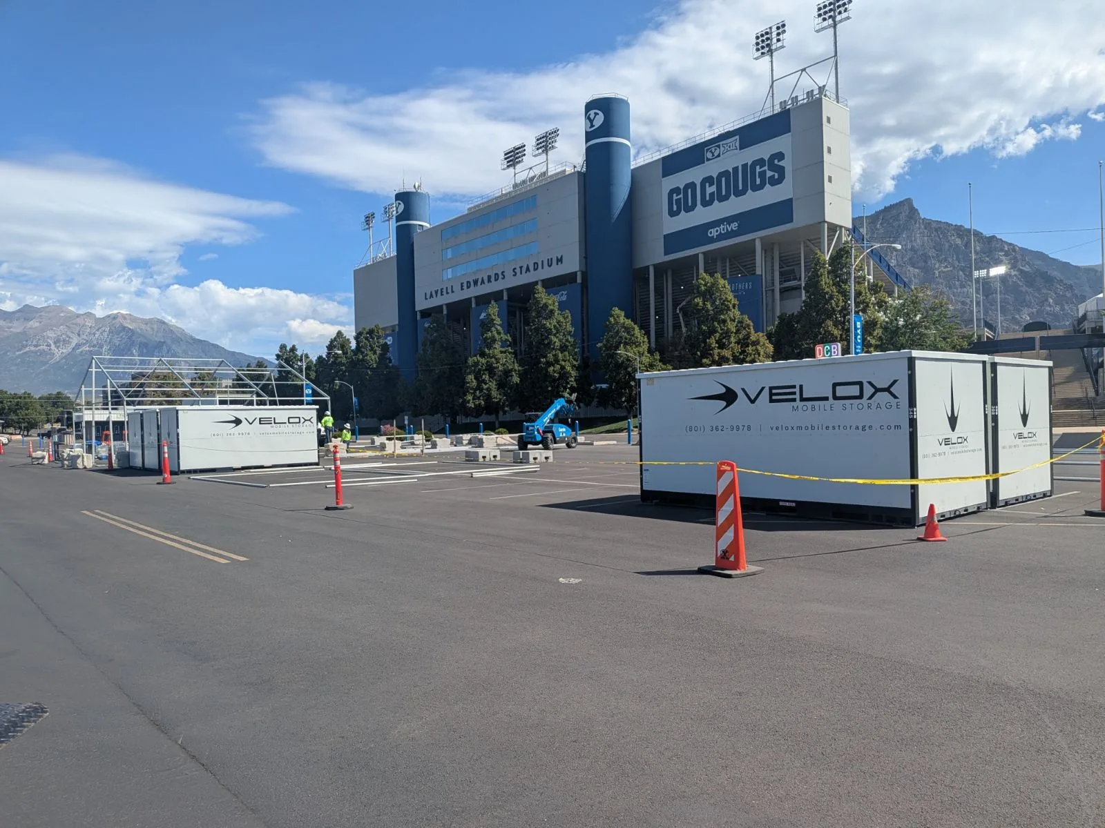 Two Velox Mobile Storage containers parked outside LaVell Edwards Stadium in Provo, Utah, with Y Mountain behind