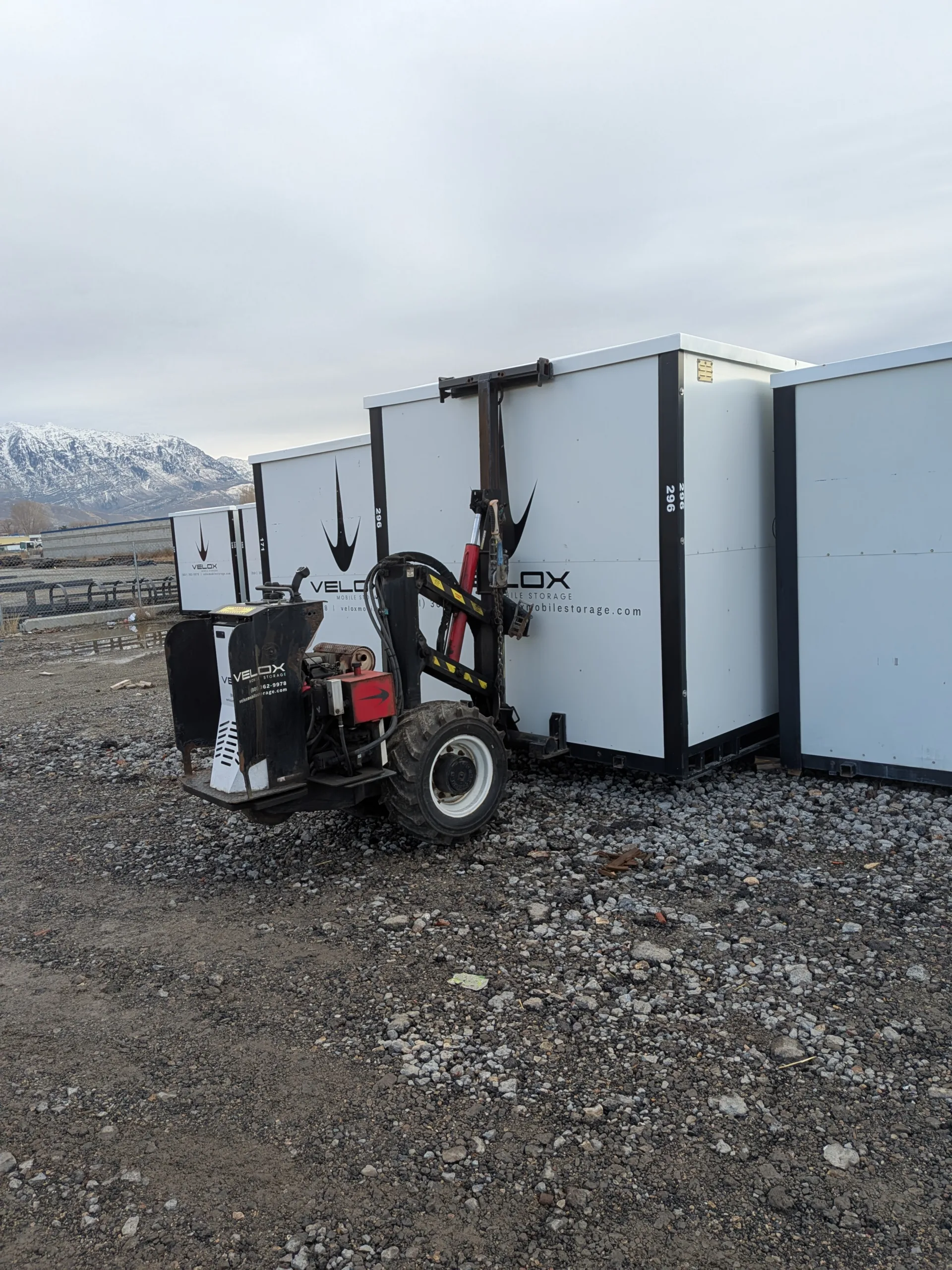 Velox Mobile Storage containers and delivery machine with snow-capped mountains behind