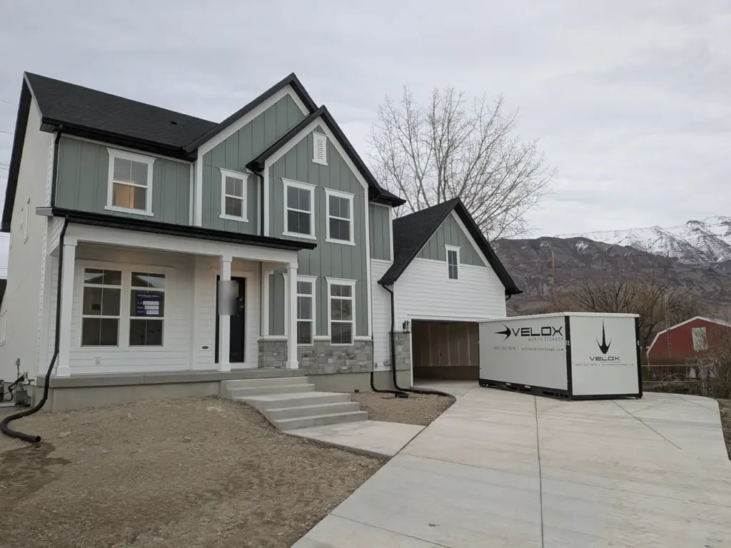 Velox portable storage container on the driveway of a brand-new home in Pleasant Grove, Utah