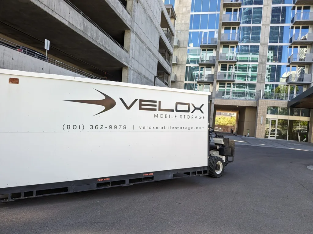 The Velox Mule moving a Velox Mobile Storage container into the driveway of a downtown Salt Lake City high-rise